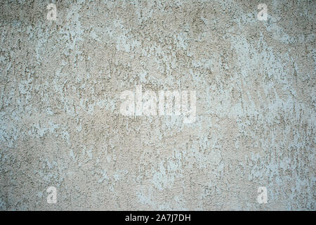 The wall of the building with a mottled surface of clay stucco gray beige shade. Background. Stock Photo