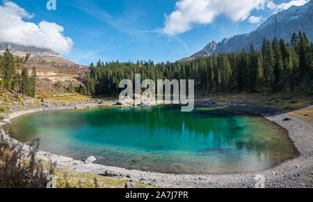 Lake Carezza or Karersee lake with deep blue colored water and the dolomite mountain range Trentino Alto Adige Region, Italy, Europe. Stock Photo