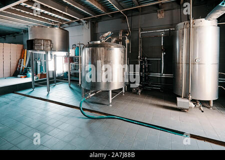 Fermentation mash vats or boiler tanks in a brewery factory. Brewery plant interior. Stock Photo