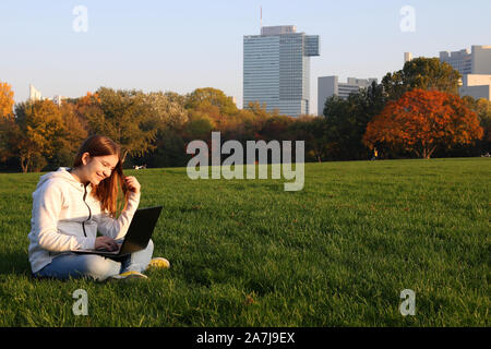 happy teenage girl with laptop in park Stock Photo