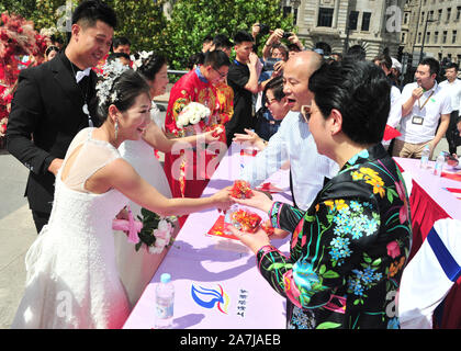 A couple receive gifts from parents at the group wedding by the Huangpu river in Shanghai, China, 19 September 2019.   15 couples held group weddings Stock Photo