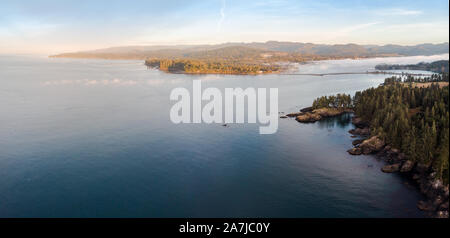 Aerial view of a bank of sea fog moving down a bay over a the rugged Vancouver Island coastline. Stock Photo