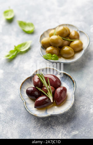 Kalamata and Green Olives on bright wooden background. Close up. Stock Photo