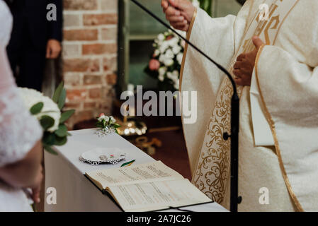 wedding rings in church with tools for ordination Stock Photo