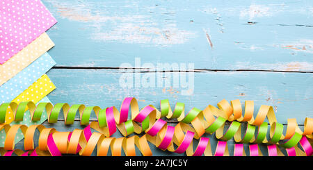 Colorful napkins and streamers on wooden table with copyspace, concept festivity decoration Stock Photo