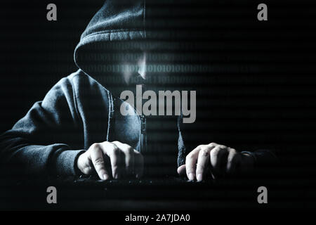 concept hacker and internet crime, man in the dark Stock Photo