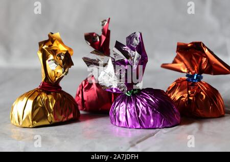 Close-up of assorted chocolates in  colourful wrappers Stock Photo