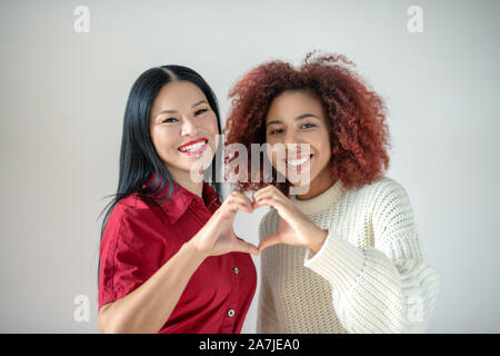 Asian woman with red lips standing near her best friends Stock Photo
