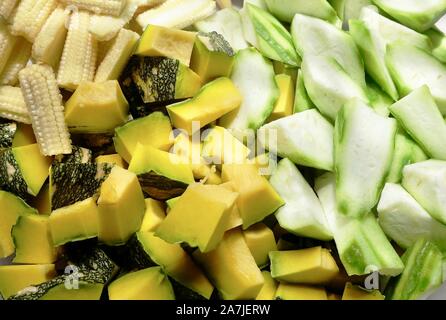 Vegetable, Closeup Raw Chopped Pumpkins, Angled Gourds or Sponge Gourds and Baby Corns. Stock Photo