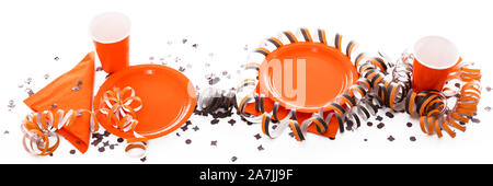 banner with halloween party decoration in orange and black, with paper plates and cups. in front of white background Stock Photo