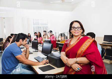 Group of College Students With Teacher Studying Computer E-Learning Eduation At Computer Class Stock Photo