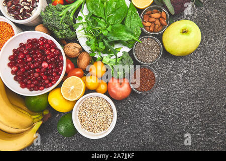Alkaline diet food, Clean eating. Healthy vegetarian seasonal, fall food cooking background. Flat lay of Autumn vegetables and herb over grey concrete Stock Photo