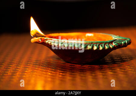 Clay diya lamps lit during diwali celebration Greetings Card Design Indian Hindu Light Festival called Stock Photo