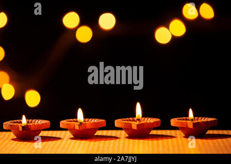 Close-up Diya oil-lamp Lighting On Diwali Festival celebrations in-India Stock Photo