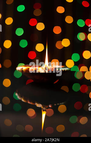 diwali greeting card showing illuminated diya or oil lamp or panti with Happy Diwali Stock Photo