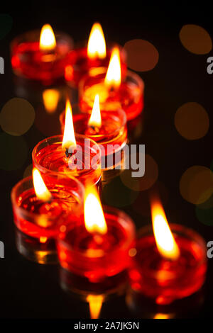 Close up Group of tea candles burning On Diwali Festival Celebration Stock Photo