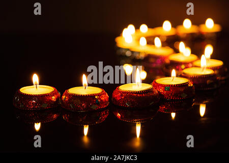 candle light in curve line dark concrete plate background for fill text on space beside Stock Photo