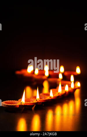 Large group of-burning Candles Arranging Queues During Diwali Festival Celebration Stock Photo