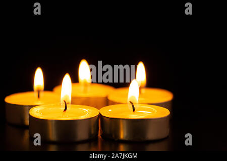 Indian Festival Diwali of-Lights focus on-foreground of-many burning tealight candles Stock Photo