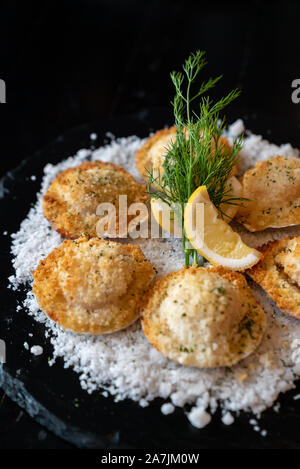 deep fried Hokkaido Scallops Shell with crusty bread serve with lemon and salt. Stock Photo