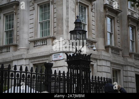 29 October 2019: Street sign, lantern and ironwork at the gates of Downing Street, London, UK, home of the UK Prime Minister and chancellor Stock Photo
