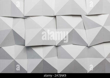 White paper folded in geometric shapes, abstract background Stock Photo