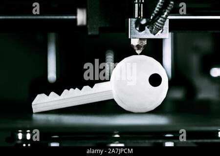 3D printer prints out a key, concepts such as advanced locksmith or new burglar and theft threat Stock Photo