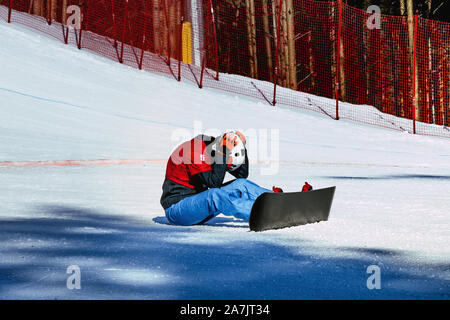 woman snowboarder on finish line failure race Stock Photo