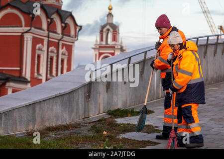 Employees of utility services remove the foliage on the territory of the Zaryadye Park in downtown of Moscow, Russia Stock Photo