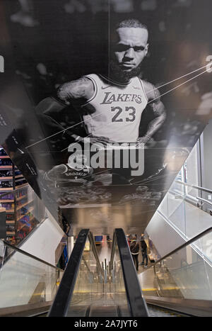 A large photo of Lebron James in  Lakers jersey above the down escalator in the NBA Store on Fifth Ave. in Midtown Manhattan, New York City Stock Photo