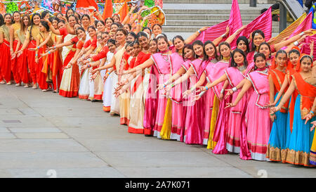 Trafalgar Square, London, UK. 3rd November 2019. Dance groups in colourful outfits at the Grand Annakut Dance opening performance with over 220 participants from all over London starts of the day of celebrations. Diwali Festival of Lights celebrations return to Trafalgar Square with dance and cultural stage performances, workshops, food and gift stalls and activities for visitors to enjoy. Credit: Imageplotter/Alamy Live News Stock Photo