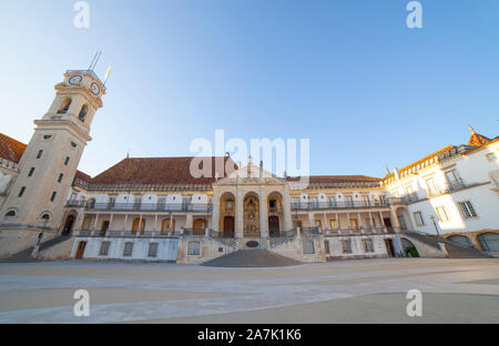 Coimbra, Portugal - Sept 6th 2019: Old Royal Palace facade and clock tower at University of Coimbra Courtyard. Blue sky background Stock Photo