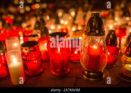 Many burning candles in the cemetery at night on the occasion souls of the deceased. Stock Photo