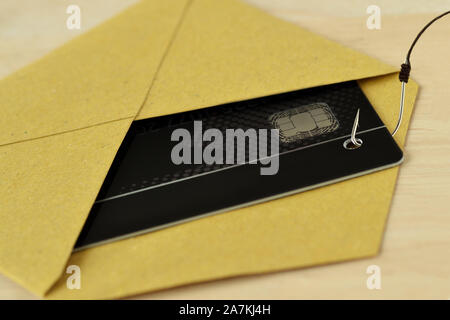Credit card in evelope with fish wook - Concept of credit card phishing and security Stock Photo