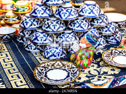 Samara, Russia - October 5, 2019: Ethnic Uzbek ceramics tableware on the table. Decorative ceramic with traditional uzbekistan ornament