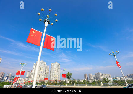 National flags are hung in various streets to celebrate the the 70th National Day of People's Republic of China in Suining city, southwest China's Sic Stock Photo