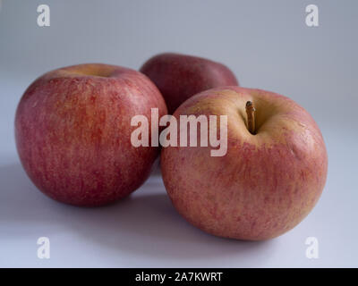 Three red apples on a white background Stock Photo