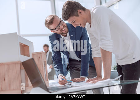 smiling colleagues discussing a new architectural project Stock Photo