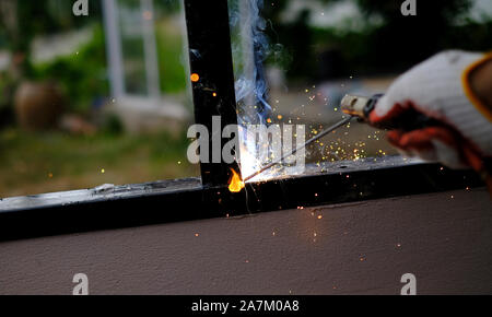 Welder Technician are welding steel with sparks flying Stock Photo