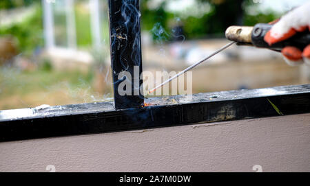 Welder Technician are welding steel with sparks flying Stock Photo