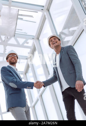 Shaking hands, Blueprints architects and building engineers talking ...