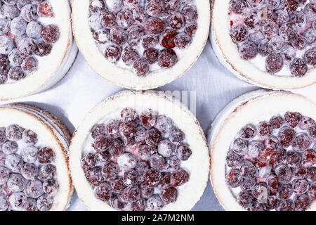 Confectionery production for the manufacture of sponge cakes with fresh cherry berries and cream, dessert. Stock Photo