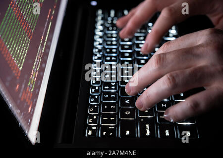 Typing on a computer keyboard - concept cybersecurity, phishing, hacking, social engineering attack, dark web, viruses and trojans Stock Photo