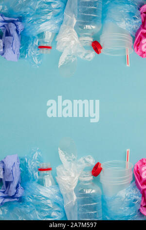 Top view of various kinds of disposable plastic waste on blue background, copy space. Stock Photo
