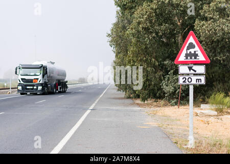 tank truck of dangerous goods on the road a foggy day Stock Photo