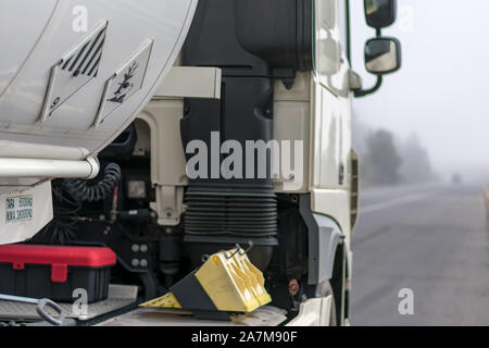 tank truck of dangerous goods on the road a foggy day Stock Photo