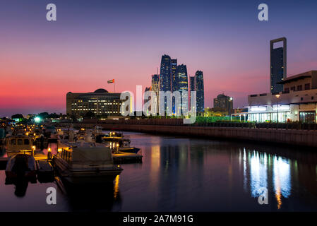Abu Dhabi modern skyline reflected in the water at twilight Stock Photo
