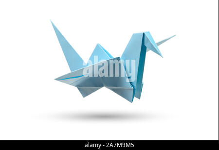 Origami flying bird isolated with clipping path. Japanese folded paper swan. Peace and hope symbol Stock Photo