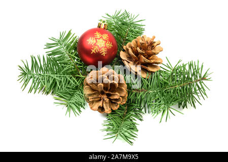 Pine cones with spruce tree branch and Christmas decoration ball on a white background Stock Photo