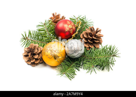 Pine cones with spruce tree branch and Christmas decoration bauble balls on a white background. Stock Photo